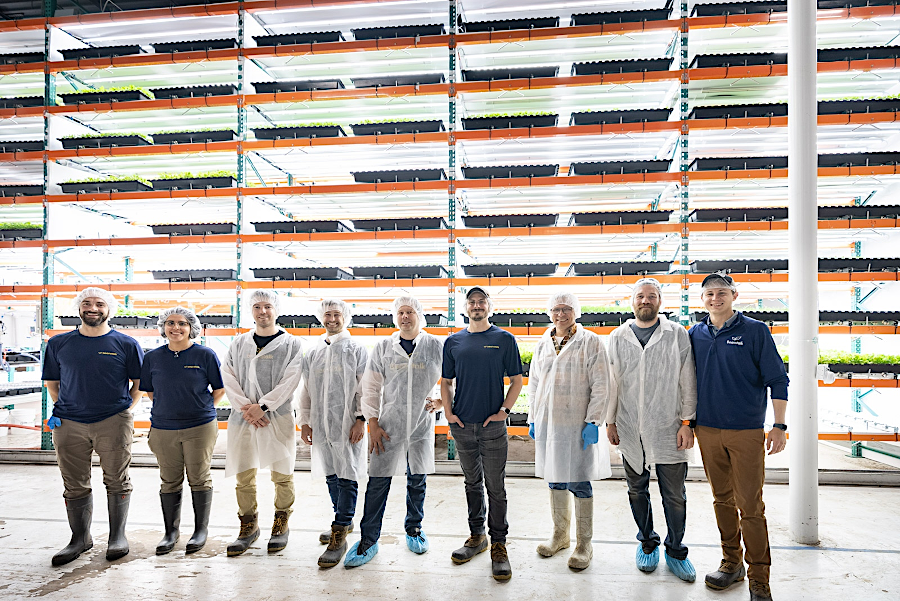 Beanstalk Farms team, in front of the world's largest vending machine