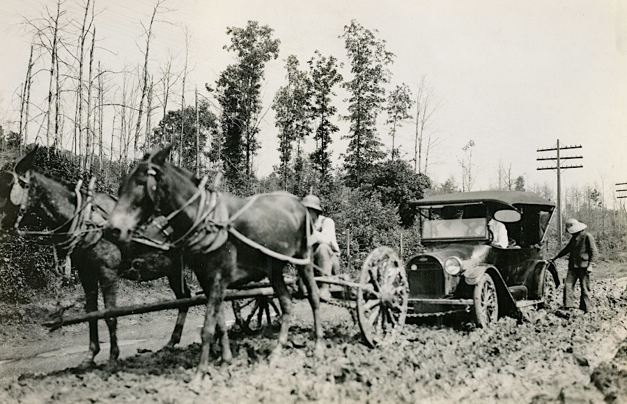 during the transition from horses to cars, local residents made money pulling vehicles through muddy spots on the unpaved road at Dumfries