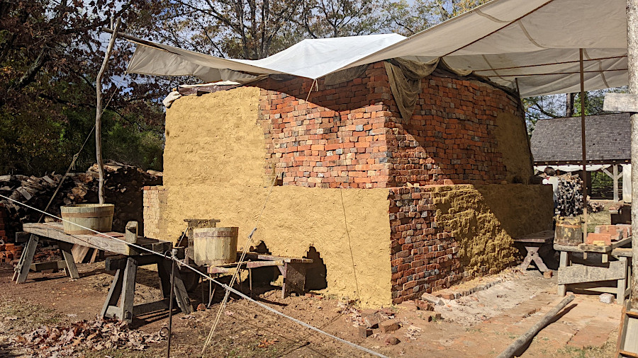 the exterior of a brick kiln was insulated with old brick and mud, with bricks to be fired stacked inside