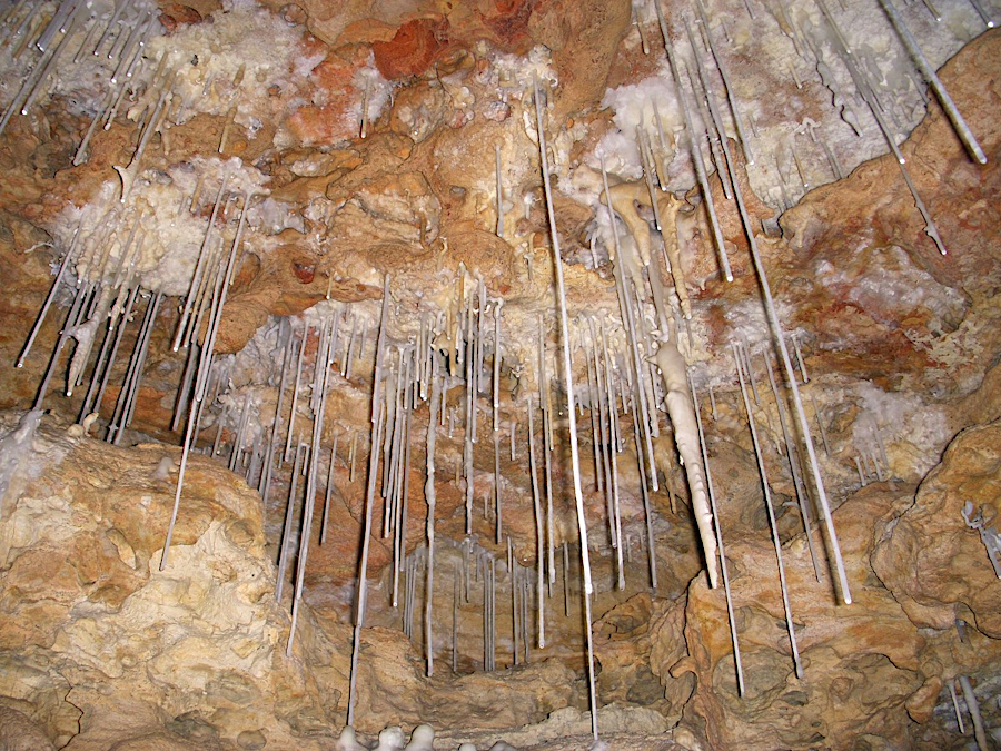 water droplets evaporating on the roof of a cave typically create  hollow soda straws first