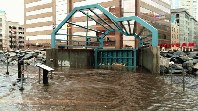 closing Norfolk's green floodwall gate (next to the USS Wisconsin) blocks water from entering the downtown district