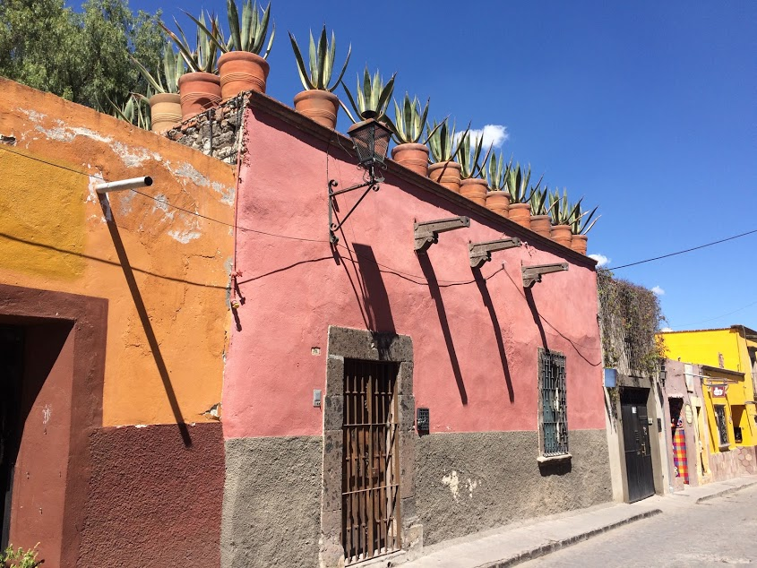 gutters and downspouts are not the same everywhere - in San Miguelle de Allende, Mexico, runoff is directed to the street over the heads of pedestrians on the sidewalk