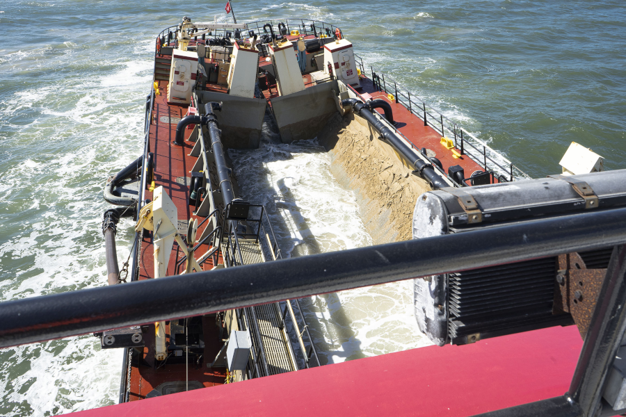 sand can be dredged from shipping channels into barges and then transported to replenish a beach