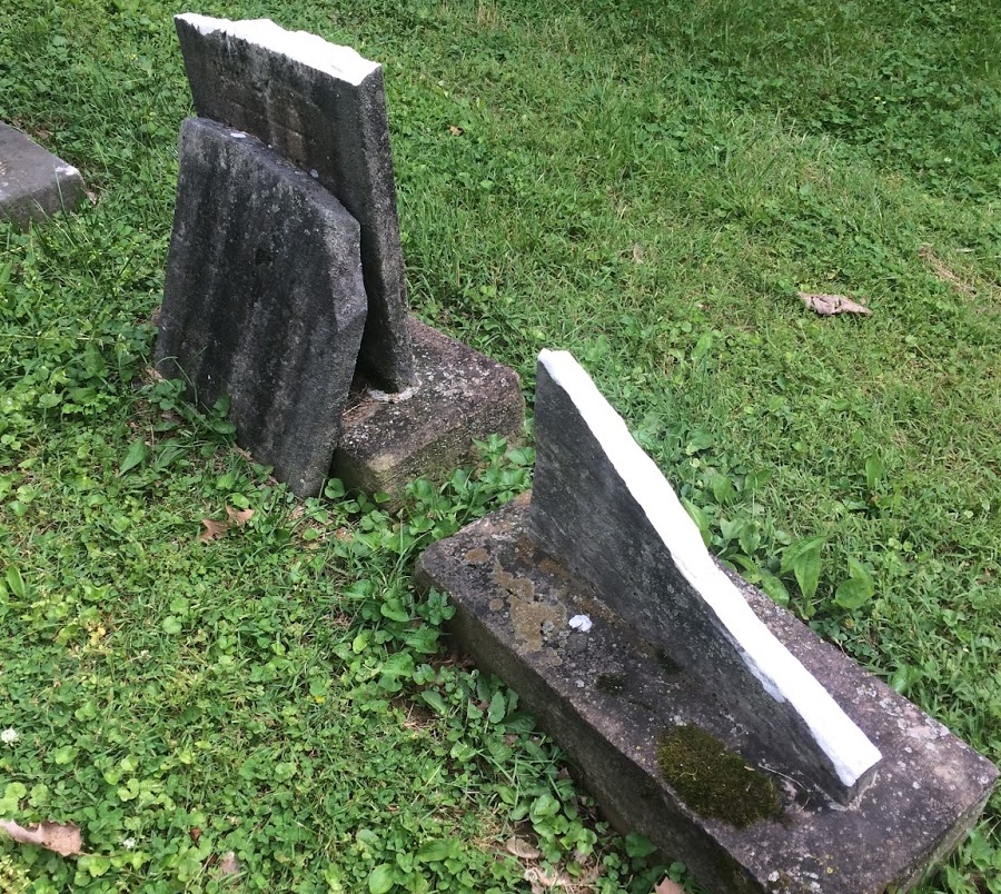 a broken tombstone reveals how white marble can develop a dark patina from soot, acid rain, and lichen