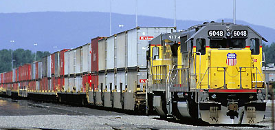 double-stacking cargo containers on trains is the equivalent of adding a second trailer to a truck on the highway, except trains get higher and trucks get longer