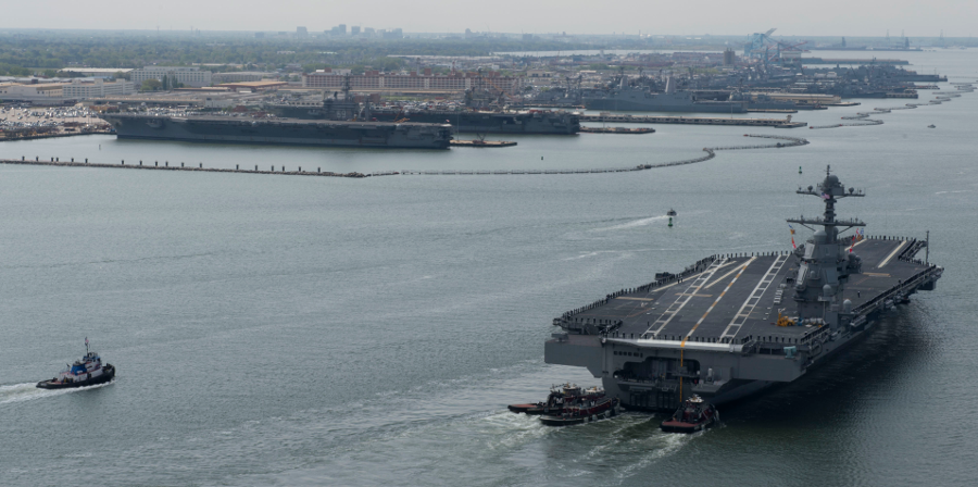 USS Gerald R. Ford approaches its berth next to the Nimitz-class aircraft carriers USS Dwight D. Eisenhower (left) and USS George Washington
