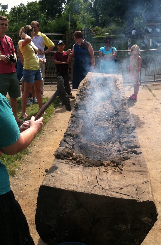 building a canoe with fire, stone scrapers, and mud to protect edges (2012 Virginia Indian Festival at Riverbend Park, Fairfax County)