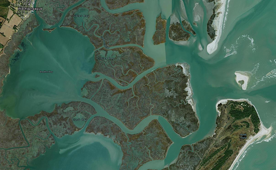 a dredged channel enables boats to get through the barrier islands east of Wachapreague