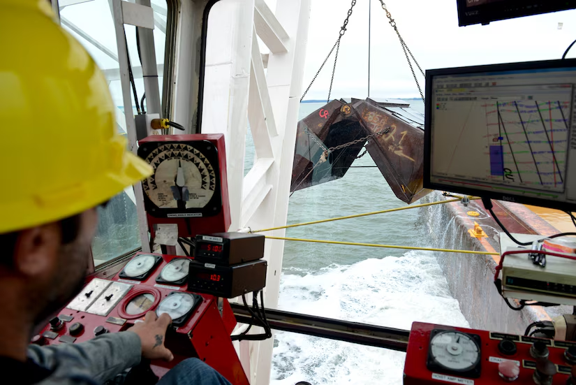 clamshells on specialized ships dig up sediments and deposit them into barges, to deepen shipping channels