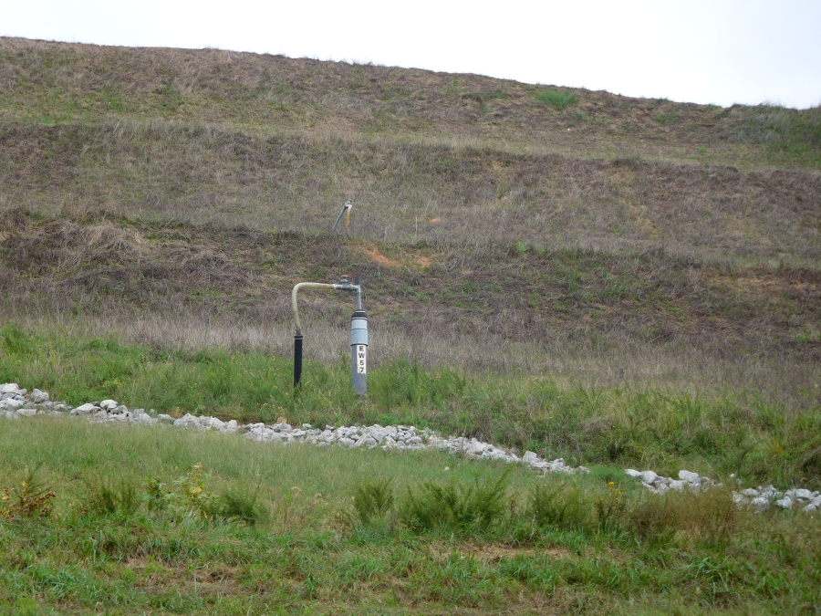 terraces and drainage ditches minimize erosion on the top of clay caps, while gas collection systems prevent pressure generated within the cell from creating cracks in the clay caps