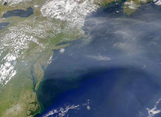 industrial haze blowing over the Atlantic Ocean