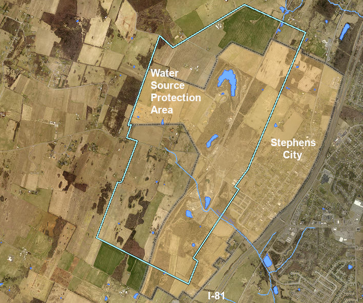 the Water Source Protection Area (blue line) includes the western half of Stephens City (shaded brown) plus land in Frederick County near the quarries